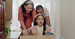 Family, new home and push in box, smile and together in house for driving game. Mother, father and kid play in cardboard, happy or excited for real estate, moving and celebrate mortgage in portrait