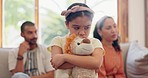 Child, sad and parents in divorce and teddy bear for comfort, support or hug in divorce argument. Depressed, kid and hearing angry mom and dad fighting in living room with trauma, fear or anxiety