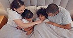 Family, parents and tickling children in bed from above for love in the morning or to wake up together. Mother, father and kids having fun in the bedroom of home on a weekend, vacation or holiday