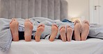 Sleeping, feet and family in a bed relax, dreaming or bond in vacation freedom at home. Barefoot, love and children with parents in a bedroom wake up from sleep, nap or resting, calm and peaceful