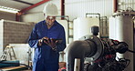 Tablet, manufacturing and machinery with a black man engineer in a factory for inspection or maintenance. Technology, industry an equipment with a contractor in a plant or warehouse for repair