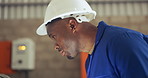 Face, helmet and black man construction worker in a warehouse closeup for manufacturing or production. Safety, industry and engineering with a plant worker in a factory for maintenance or inspection
