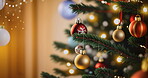 Christmas tree, decoration and tradition. Colorful ornaments in house with light, bokeh and movement. Holiday celebration interior party decor of family home for festive season with hanging detail.