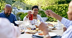 Family, lunch and talking with talking in garden, drink and food to relax in conversation at thanksgiving. Black woman, African man and giving juice with salad, meat or care at event, party or brunch
