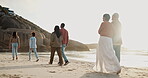 Beach, holiday and big family walking on vacation, travel or relax at the sea together. Generations, mother and father with grandparents and kids on journey or adventure with love, support and care