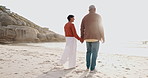 Back, holding hands and an old couple walking on a beach together at sunset for romance in summer. Travel, nature or freedom with an elderly man and woman on the sand by the ocean or sea for bonding