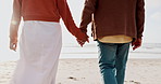 Back, holding hands and a couple walking on the beach together at sunset for romance in summer. Travel, nature or freedom with a man and woman on the sand by the ocean or sea for bonding closeup