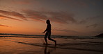 Girl kid, silhouette and sunset by ocean, playing and splash feet with freedom, water and vacation. Child, sea or beach with game in waves, running and summer sunshine at dusk on holiday in Mexico