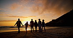 Sunset, walking and shadow of people at the beach on a summer vacation, holiday or weekend trip. Travel, evening and silhouette of family holding hands by the ocean or sea on tropical getaway.