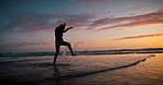 Child, run and splash in sunset, ocean and playing with silhouette, feet and freedom in water on vacation. Girl, sea and beach for game in waves, jump and summer sunshine at dusk on holiday in Mexico