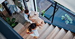 Happy family, door and running up stairs in new home, property or investment moving in together above. Top view of parents and excited children in relocation, building or explore apartment at house