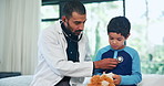 Doctor, boy child and stethoscope in clinic with lion toys for healthcare, assessment and check breathing. Medic, pediatrician and helping kid with lungs, cardiology and wellness on bed in hospital