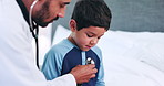 Pediatrician man, boy and stethoscope for breathing, bed and consultation in house, healthcare and assessment. Medic, doctor and child for lungs, cardiology and check with questions in home bedroom