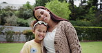 Family, love and a daughter hugging her mother in the garden of their home for summer bonding together. Portrait, smile or happy with a young woman parent embracing her girl child in the backyard