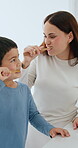 Smile, oral care and a family brushing teeth in the bathroom of their home together for morning routine. Toothbrush, toothpaste or hygiene with a mother and son cleaning their mouth for dental