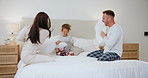 Bedroom, pillow fight and child with parents playing for love, bonding and loving relationship. Family, home and happy mother, father and young girl with pillows for playful, games and relax on bed