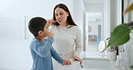 Dental, oral hygiene and a family brushing teeth in the bathroom of their home together for morning routine. Toothbrush, toothpaste or care with a mother and son cleaning their mouth in an apartment