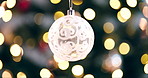 Globe, new year and Christmas with festive lights hanging on tree with bokeh background. Closeup of ornament, decoration or December season for celebration, festivities or holiday weekend at home