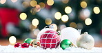 Christmas, celebration and festive with decorations on the floor for the holiday season closeup. Event, december and baubles in snow in the living room of a home for celebration or tradition