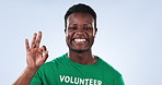 Volunteer, happy black man or studio ok sign for charity feedback, pollution support agreement or community service vote. Okay emoji icon, climate change help or NGO model portrait on blue background