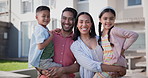 Family, children and outdoor by new house for real estate, property investment and mortgage in neighborhood. Face or portrait of happy interracial parents, mom and dad with kids in backyard of home