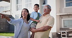 Happy, pointing and child with mother and grandfather standing in garden of new family home. Smile, conversation and boy kid bonding with young mom and senior man by house or real estate together.