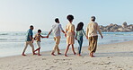 Happy family, walking or holding hands on beach with love or nature to relax for calm holiday. Generations, parents and grandparents with kids for care and travel vacation by coast for peace wellness