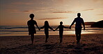 Family silhouette, walking on beach and holding hands for support, holiday and summer vacation in sunset. Back of parents with kids shadow by ocean, sea or nature for love, care and outdoor wellness