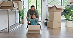 Happy dad, box and playing with girl in new home for real estate, bonding or property investment. Father pushing child with smile for fun playful relocation, renovation or moving in house together