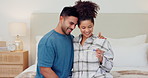 Happy couple, bed and hug with pregnancy test in support, love or care together for maternity at home. Excited man and woman smile for pregnant exam, positive results or family in bedroom at house