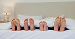 Sleeping, feet and family in a bed relax, bond and calm with support, security or peace in their home. Foot, love and children with parents in a bedroom for resting, sleep and dreaming, nap or safety