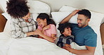 Family, tickle and playful in bed, laughing and bonding at home, fun and silly humor or comedy. Parents and children, connection and security in relationship, happy and care in bedroom, love or goofy