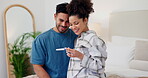 Couple, hug and pregnancy test for positive result, smile and happiness for baby, fertility and love. People, pregnant and celebrate for future, maternity and support at home, embrace and bonding