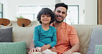 Happy, smile and face of father and child on a sofa for bonding and relaxing together at home. Excited, love and young Indian dad with boy kid in the living room of modern house or apartment.