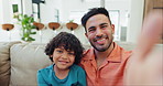 Selfie, smile and face of father and child on a sofa for bonding and relaxing together at home. Happy, love and young Indian dad taking a picture with boy kid in the living room of modern house.