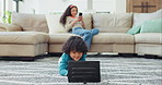 Child, youth and tablet for streaming in home on web, internet and online app for entertainment. Kid, little boy and technology with sibling for learning, game and fun by lying, floor and living room