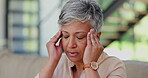 Elderly, woman and headache or massage temple for pain relief, frustrated or mental health on sofa in living room. Senior, person or migraine, vertigo and depression on couch in lounge for retirement