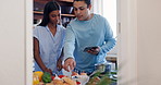 Love, cooking and couple with phone in the kitchen with recipe on the internet for breakfast on weekend. Technology, conversation and young man and woman preparing healthy meal for lunch in apartment