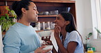 Couple, feeding and laugh in kitchen food for romance connection, breakfast fruit or wellness partnership. Man, woman and spoon in taste cereal or love cooking, nutrition smile diet or hungry helping