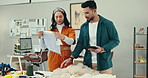 Designer man, woman and tablet with cloth in workshop for choice, planning or fashion for thinking, talk or vision. People, partnership and stylist team for decision, manufacturing or app in factory