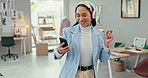 Happy woman, phone and dancing to music in fashion with headphones in relax or break at office. Creative female person or employee enjoying audio streaming or listening at clothing boutique workplace