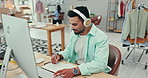 Music, writing and fashion designer man at work in office with computer for creative planning or research. Smile, notebook and headphones with happy small business or startup employee in a workplace