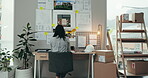 Business woman, architecture and planning at office desk for startup project, floor plan ideas or sticky note reminder. Back of professional person, interior designer or creative worker brainstorming