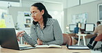 Business woman, laptop and writing in notebook, journal or planning of schedule, administration and research digital news in office. Worker reading information on computer with notes, planner or tech