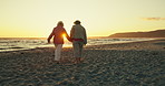 Sunset beach, holding hands and senior couple walking in nature with love, support or adventure together. Sunrise, travel or old people at sea for bonding in retirement, vacation or summer holiday