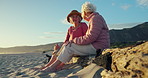 Elderly women, together and talk at beach on wood log, memory or sitting in conversation for reunion. Senior friends, people and nature with listen, chat or relax for freedom, vacation or retirement
