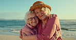 Elderly women, friends and beach for hug, face or vacation in summer, sunshine or freedom. People, retirement and happy for embrace in portrait by sea, holiday or relax outdoor on adventure in Naples