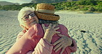 Senior women, hug and bonding on beach vacation, care and embrace on sand or relax on holiday. Elderly friends, love and smile by ocean for support in retirement, conversation and travel in outdoors