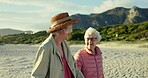 Senior women, talking and walking on beach, bonding and conversation on sand or relaxing on holiday. Elderly friends, chat and care for support in retirement, communication and traveling in outdoors