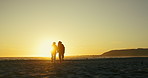 Sunset beach walk, holding hands and senior couple in nature with love, support or adventure together. Sunrise, travel or old people at the ocean for bonding in retirement, vacation or summer holiday